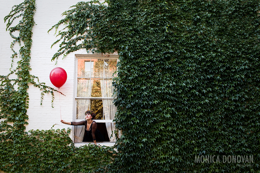 Portrait of Kat Wright holding a red balloon on an ivy wall by Vermont Photographer and photojournalist Monica Donovan based in Burlington